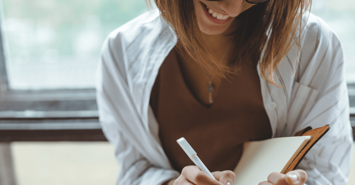 Woman writing down a checklist when moving office