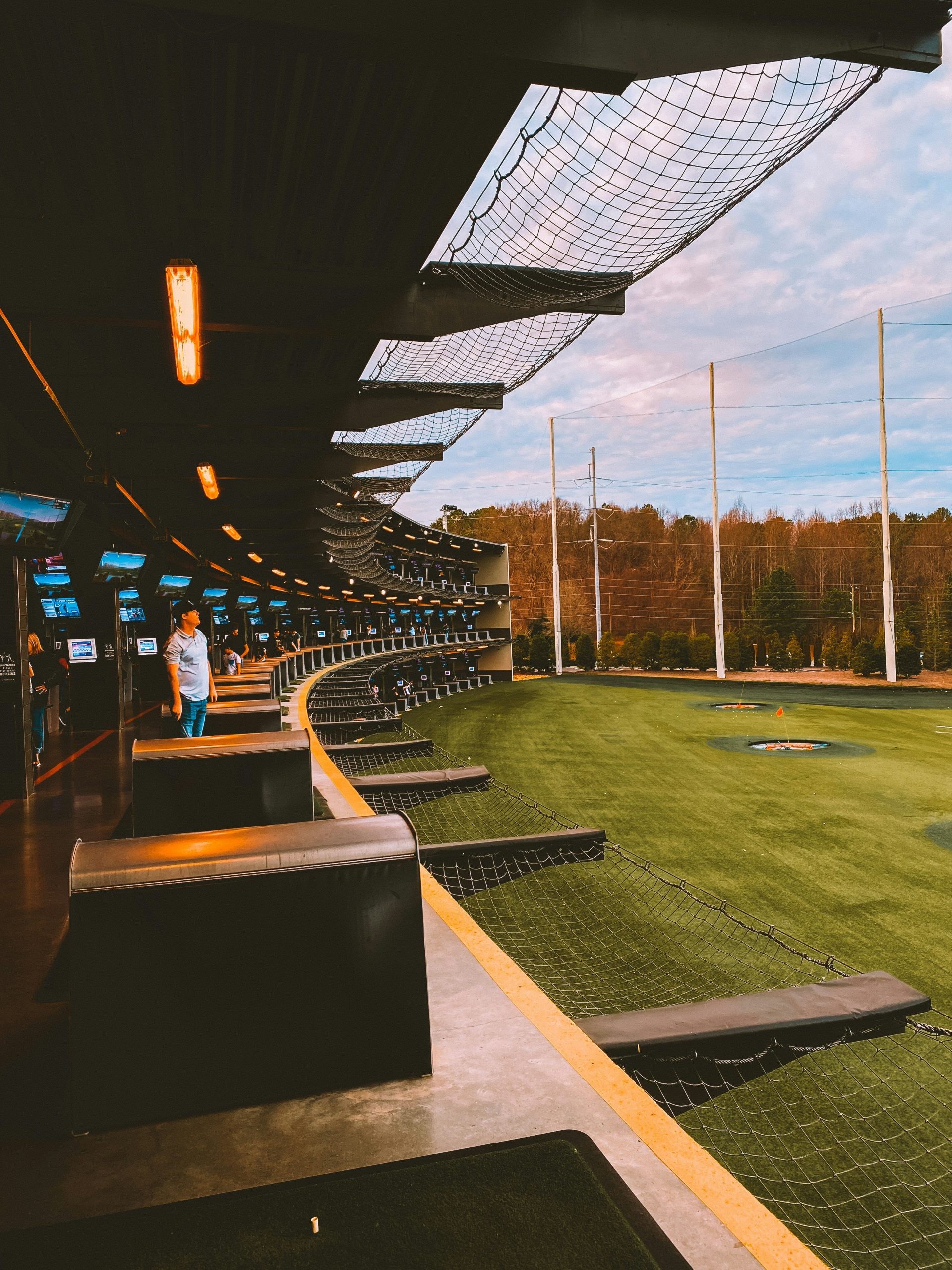 man at a topgolf in huntsville alabama's midcity district