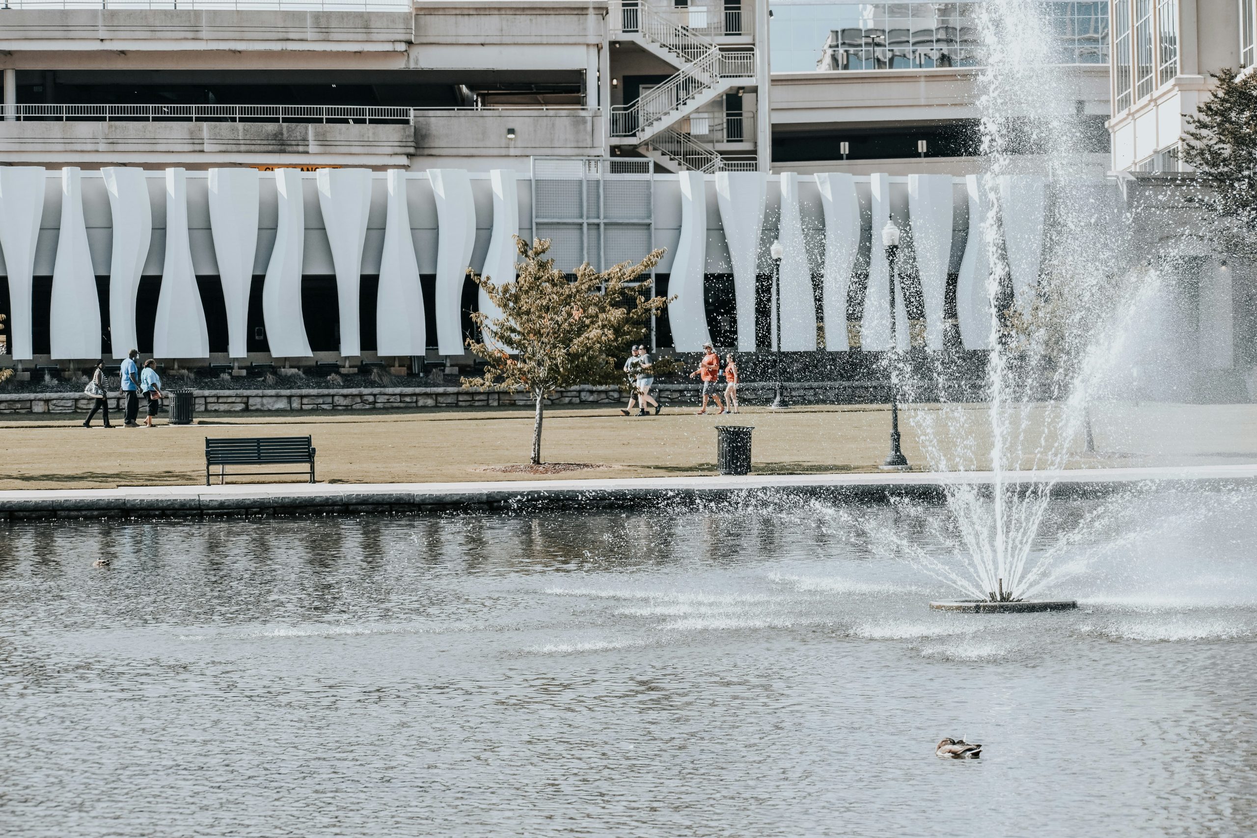 Pedestrians walk past a new waterfeature in downtown huntsville