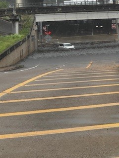 A flooded car under an underpass in Houston after Hurricane Beryl