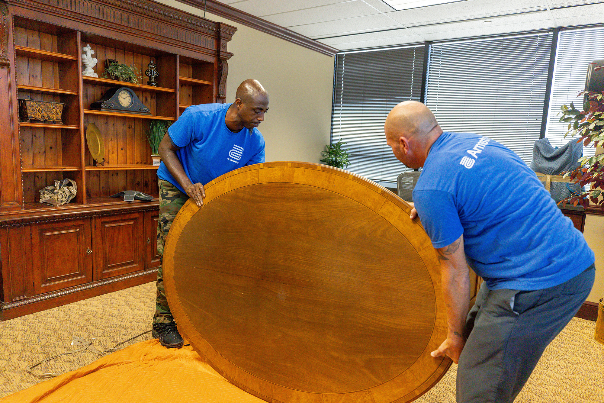 Two men moving furniture