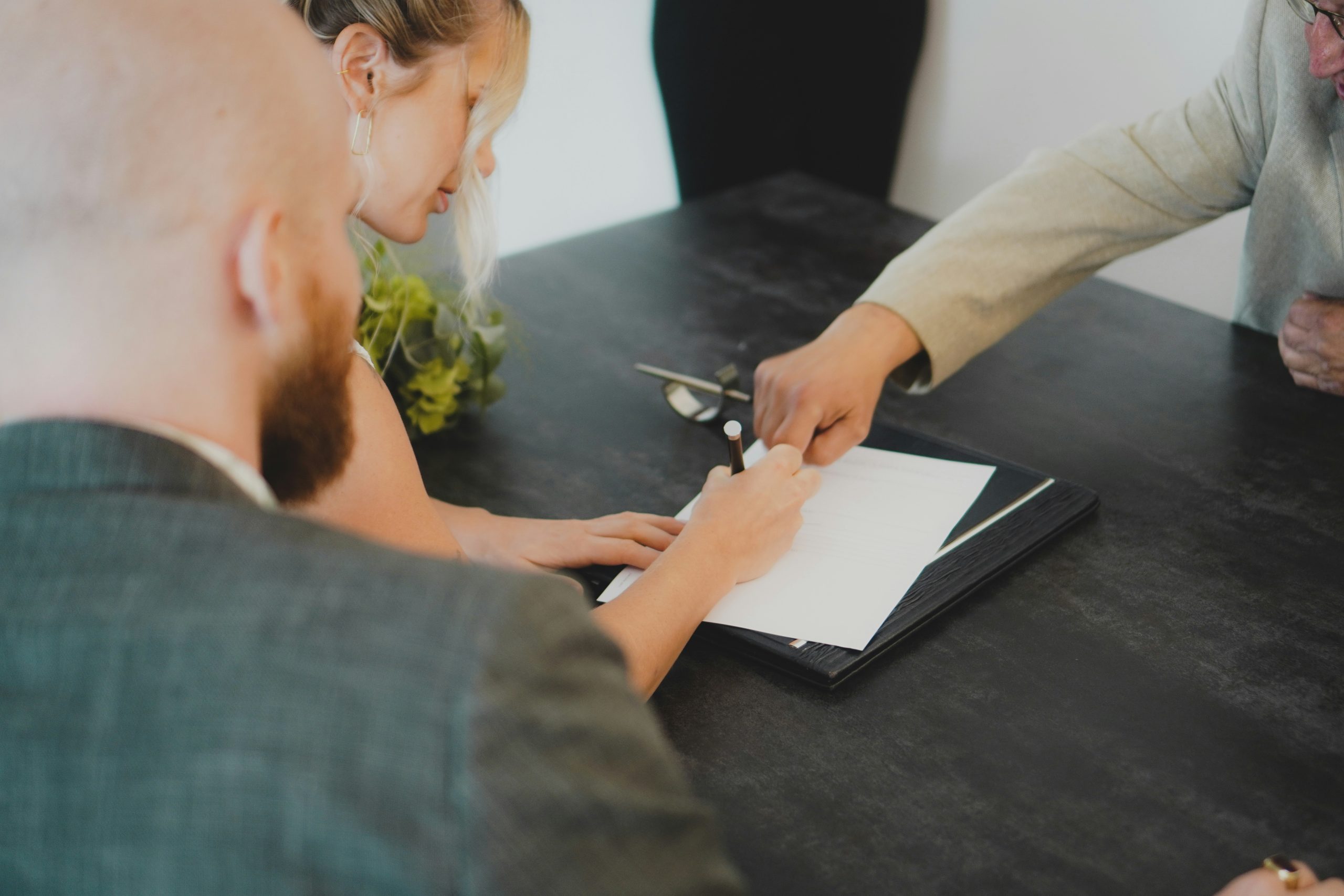 A couple signs a contract with a trusted moving company