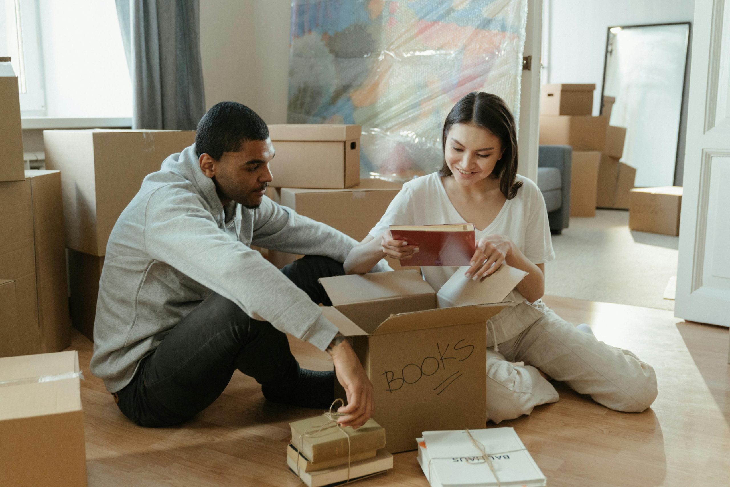 couple unpacking boxes in their new home