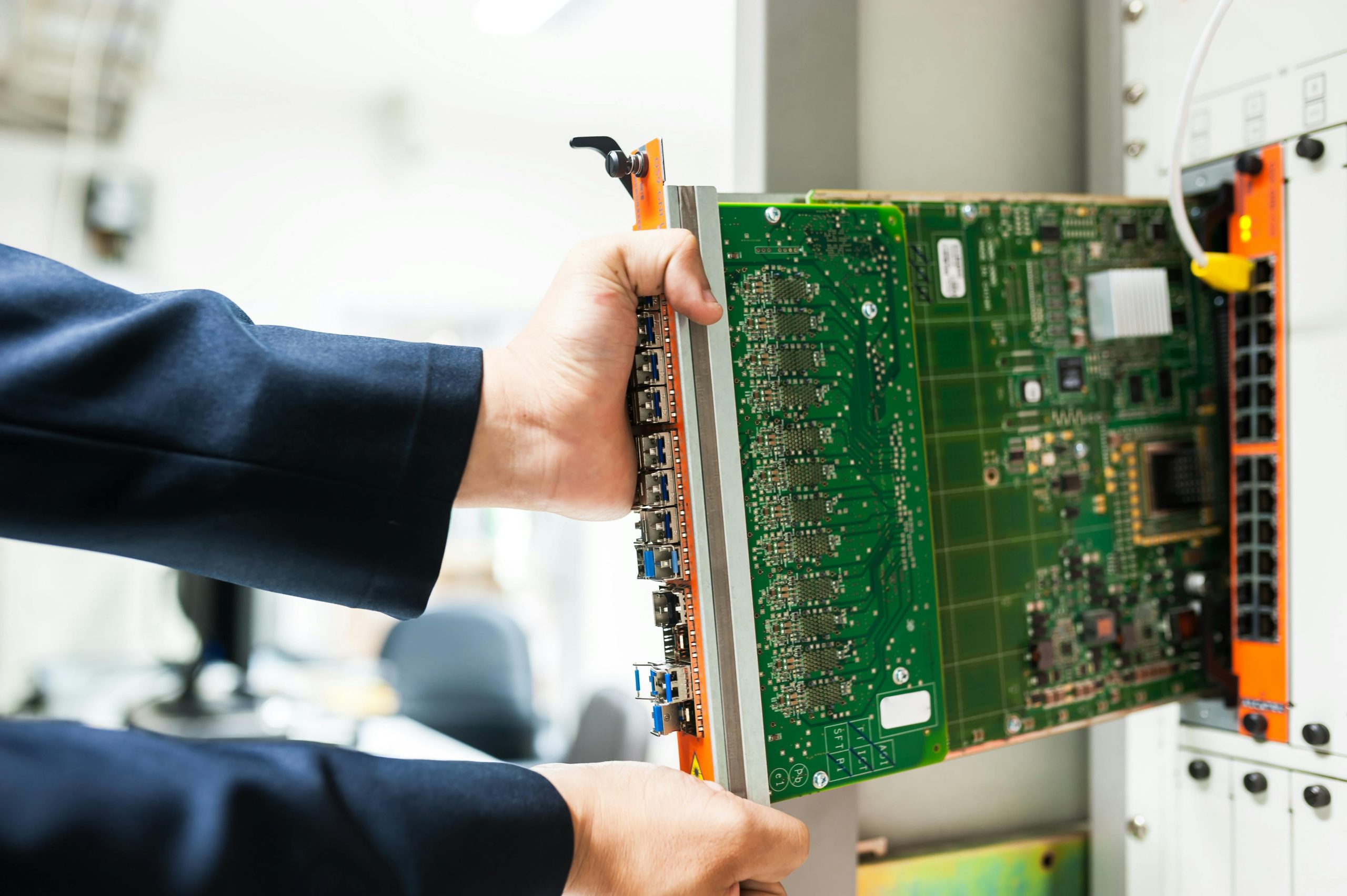 A person installing a piece of data center equipment