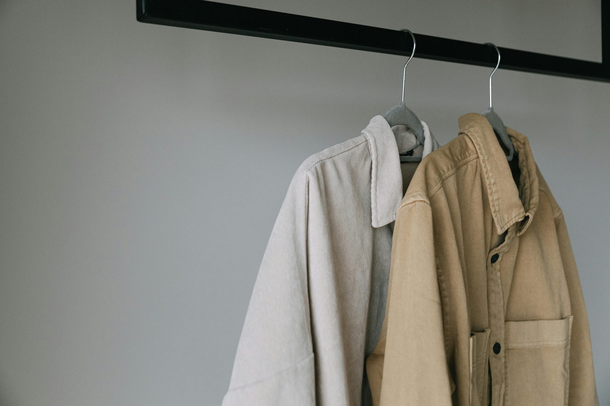 two jackets hanging in a closet